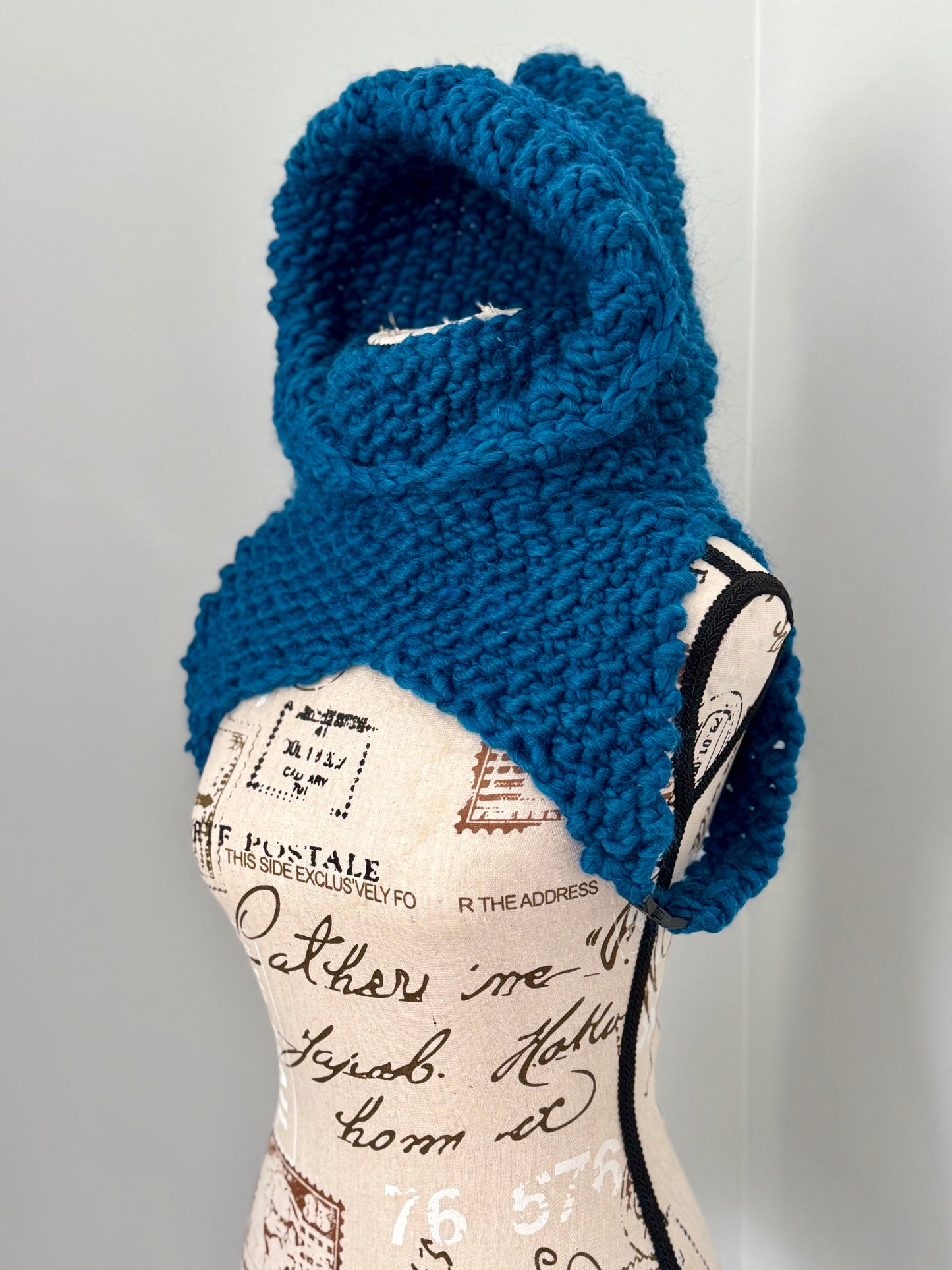 From the viral sensation this Matrix Cowl is hand knitted in marine blue and features a generous hooded cowl neckline and under arm fasteners to be layered to your liking.