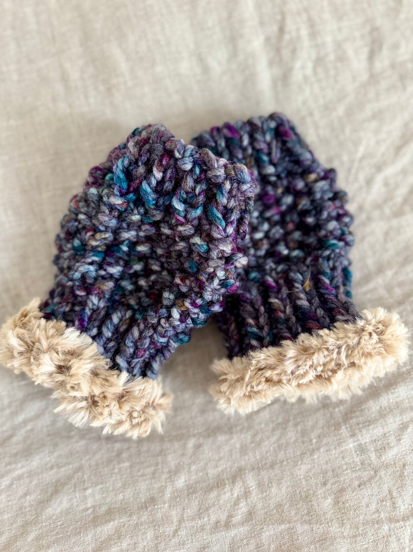 Super bulky seed stitch hand knitted hand warmers featuring faux fur edging at the wrists. Custom commission in a color of your choice.