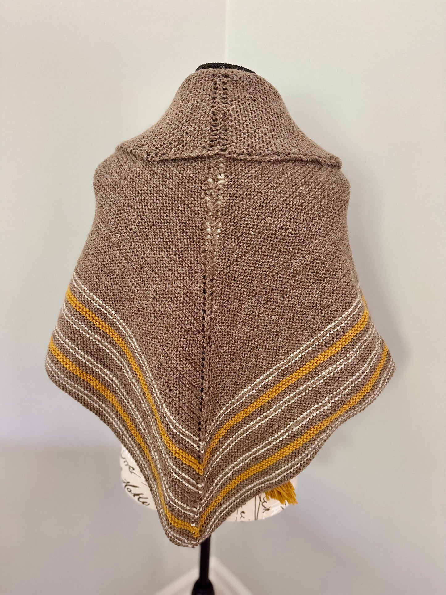 Hand knitted natural brown triangular wrap around shawl featuring stripes and handmade tassles. Custom Commission in a color of your choice.