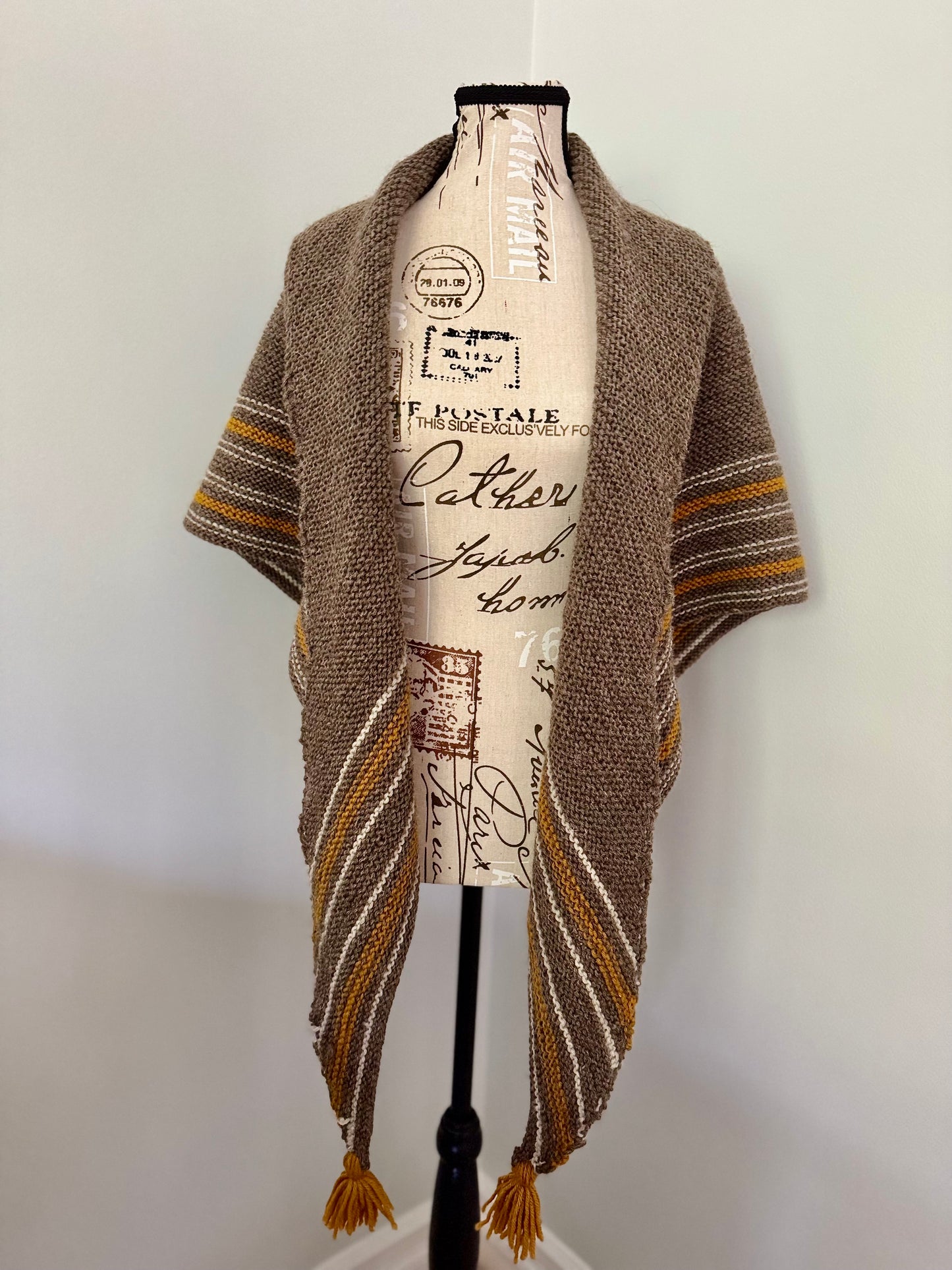 Hand knitted natural brown triangular wrap around shawl featuring stripes and handmade tassles. Custom Commission in a color of your choice.