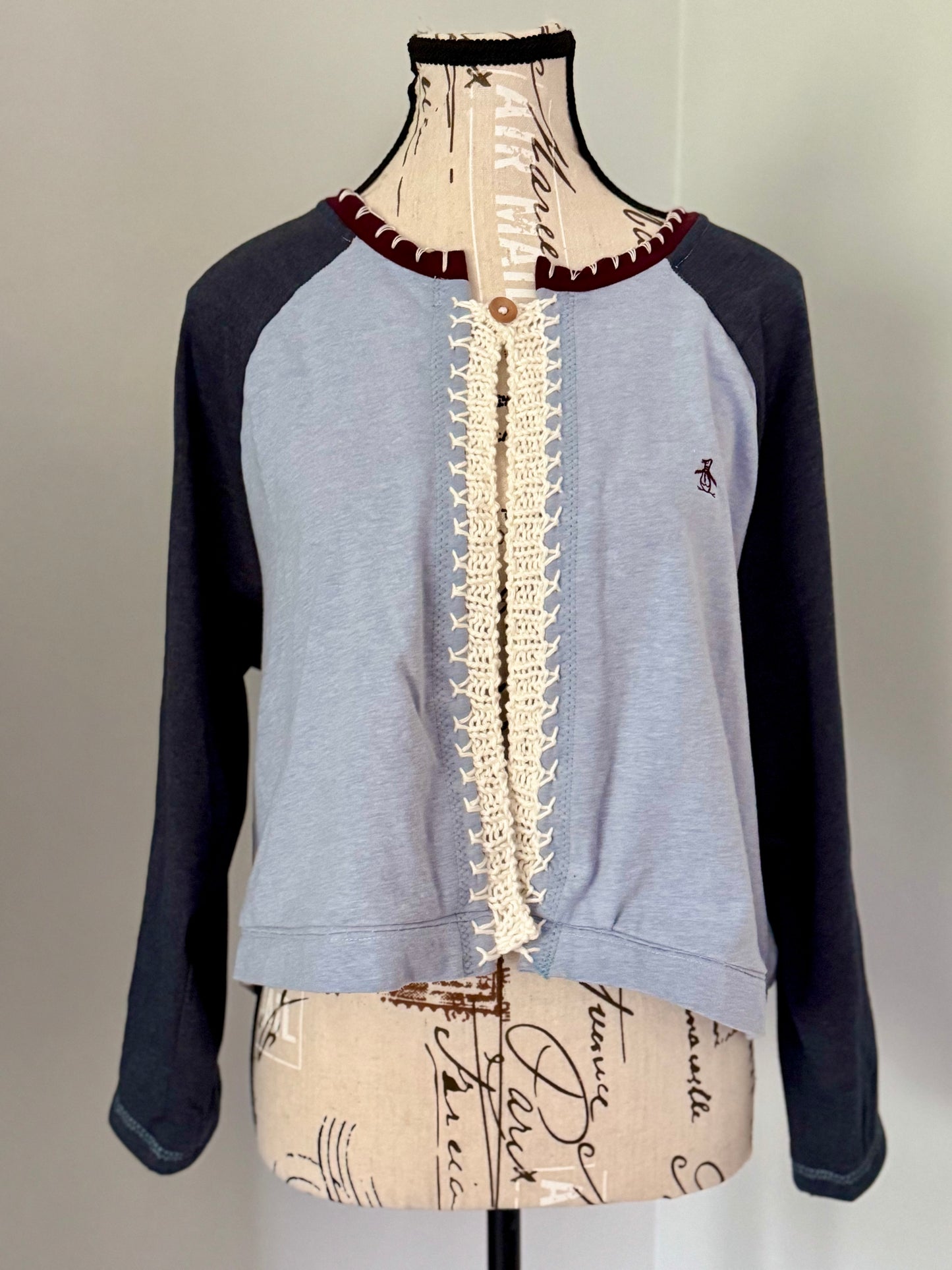 Upcycled blue raglan t-shirt trimmed with white hand knitted stitch work