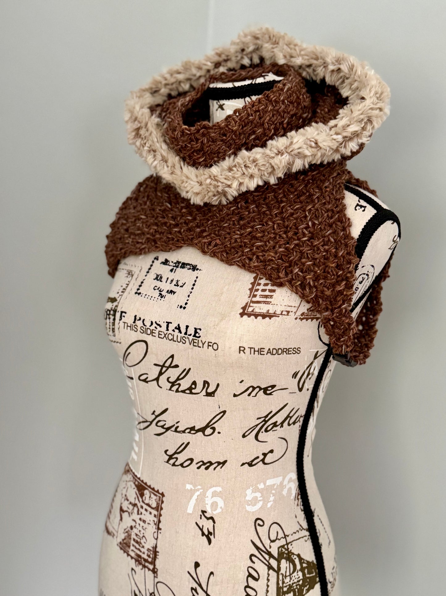 From the viral sensation this Matrix Cowl is hand knitted in tweed brown and features a generous faux fur trimmed hooded cowl neckline and under arm fasteners to be layered to your liking.
